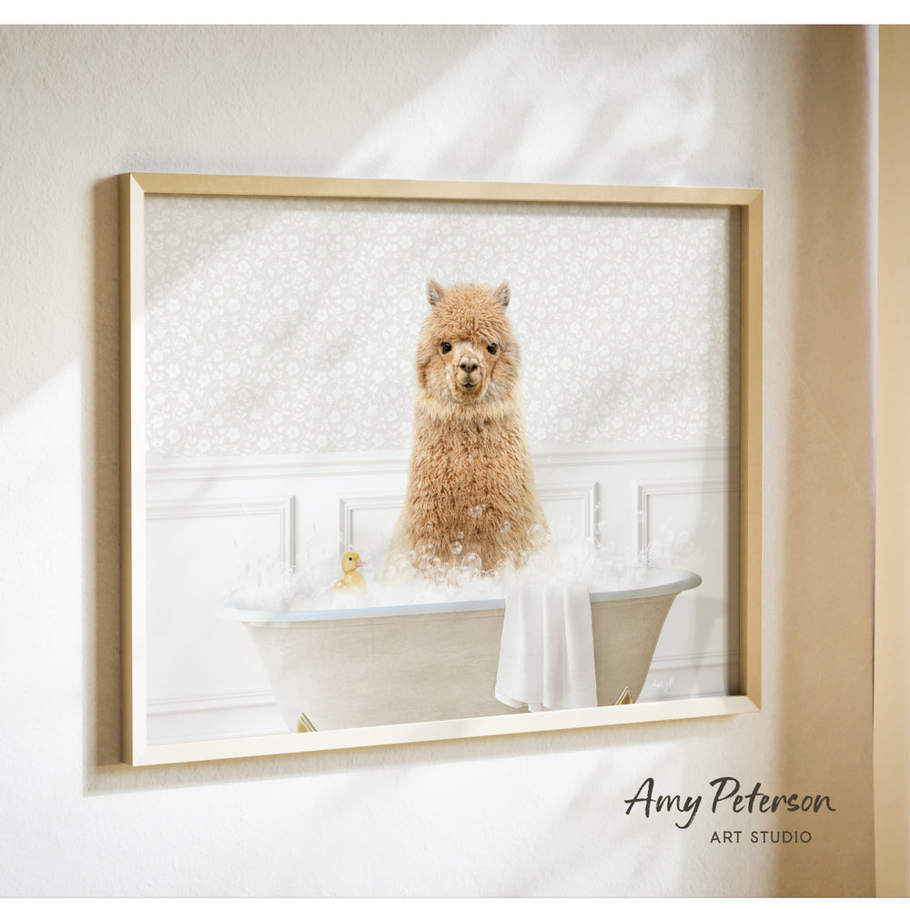 A brown alpaca sitting in a bathtub filled with bubbles, with a yellow duck floating nearby.