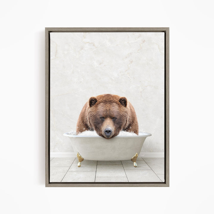A brown bear is sitting in a white bathtub, appearing relaxed and enjoying the bath.