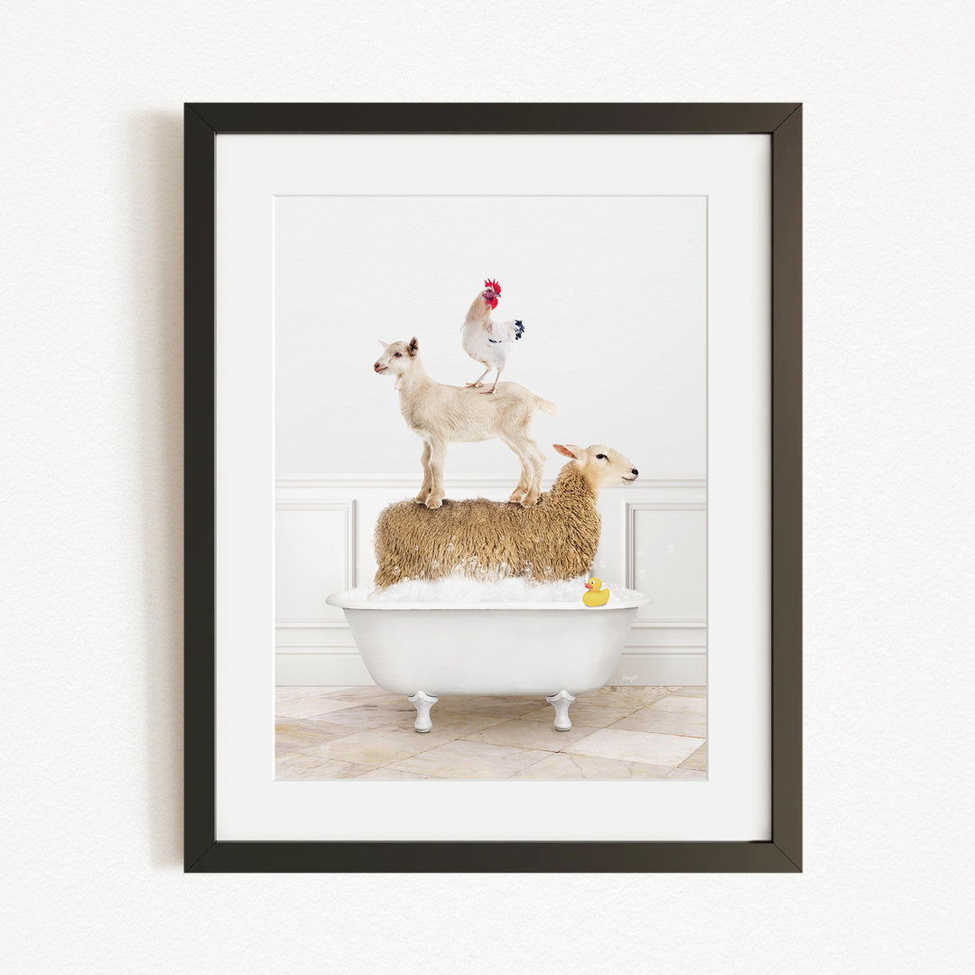 A framed image depicting a goat standing on a sheep's back while a rooster stands on top of a sheep in a bathtub.