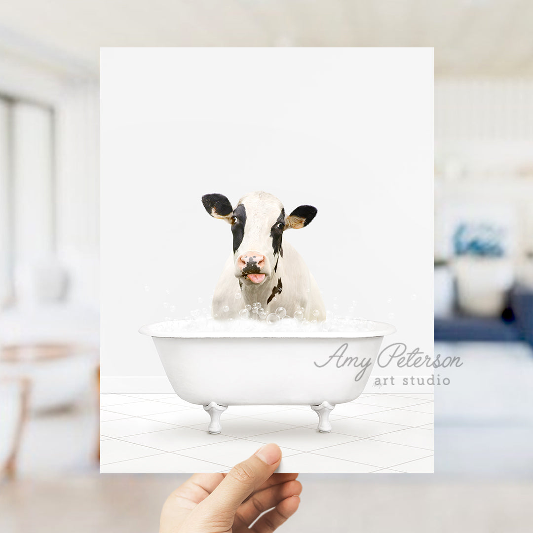 a person holding up a card with a picture of a cow in a bathtub