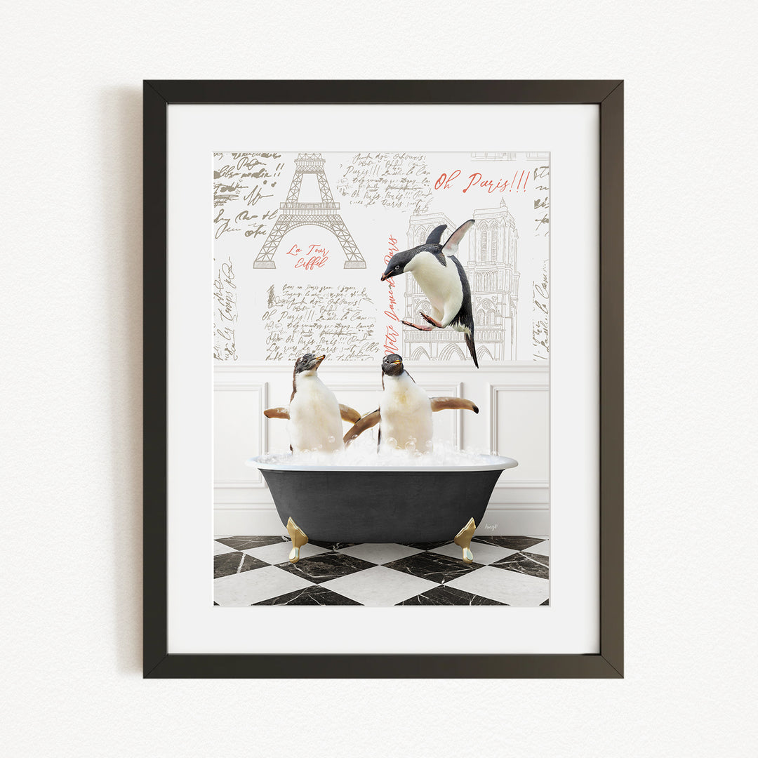 A framed image depicting two penguins sitting in a bathtub, with one penguin standing on the edge of the tub and the other penguin sitting inside the tub.