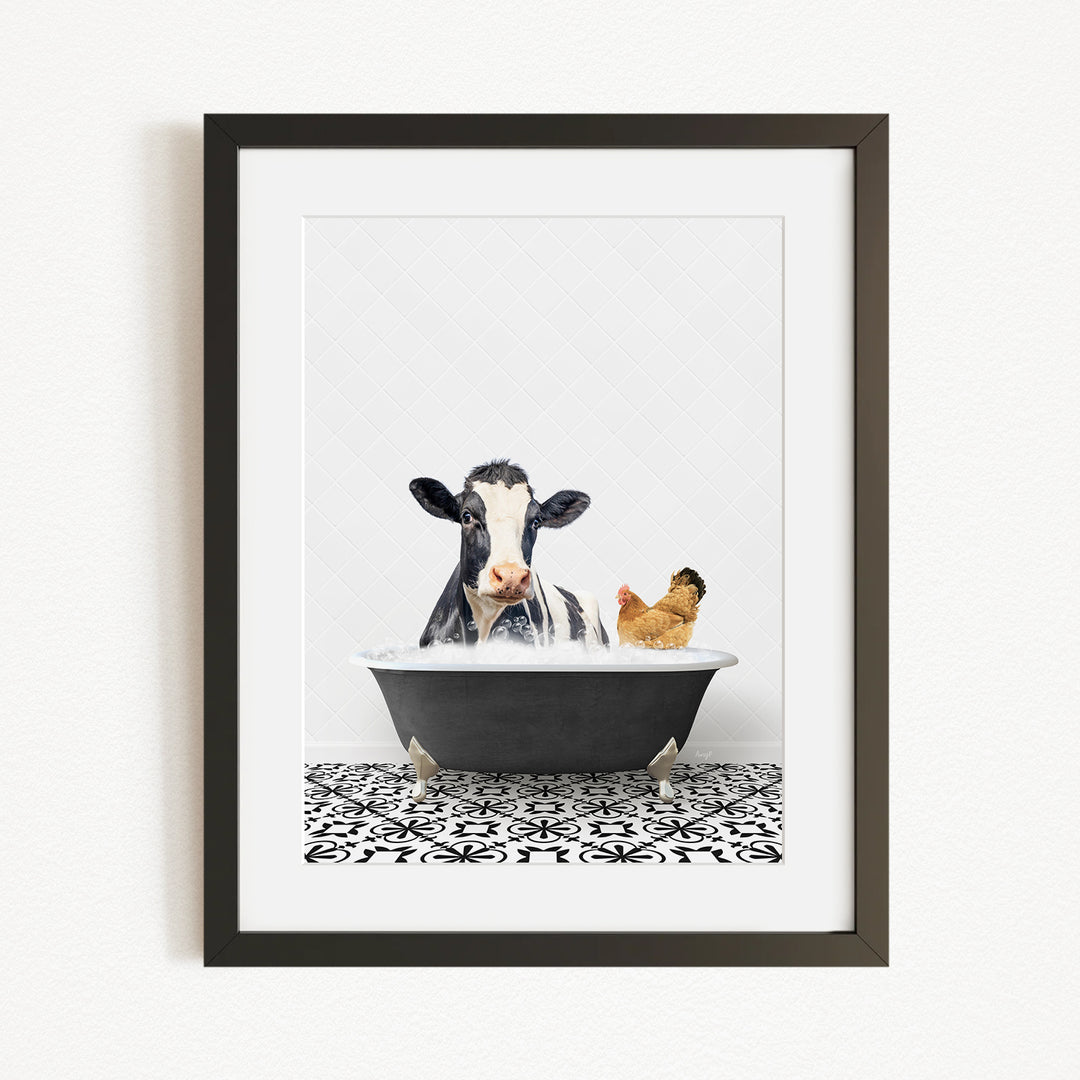 A framed image depicting a cow and a chicken relaxing in a bathtub together.