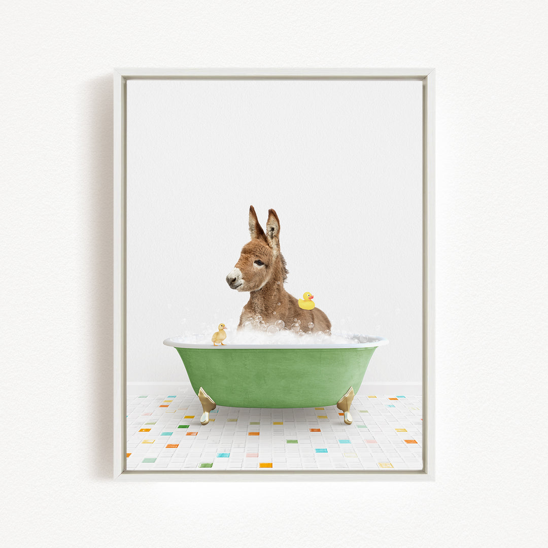 A donkey is sitting in a green bathtub filled with water, surrounded by several rubber ducks.