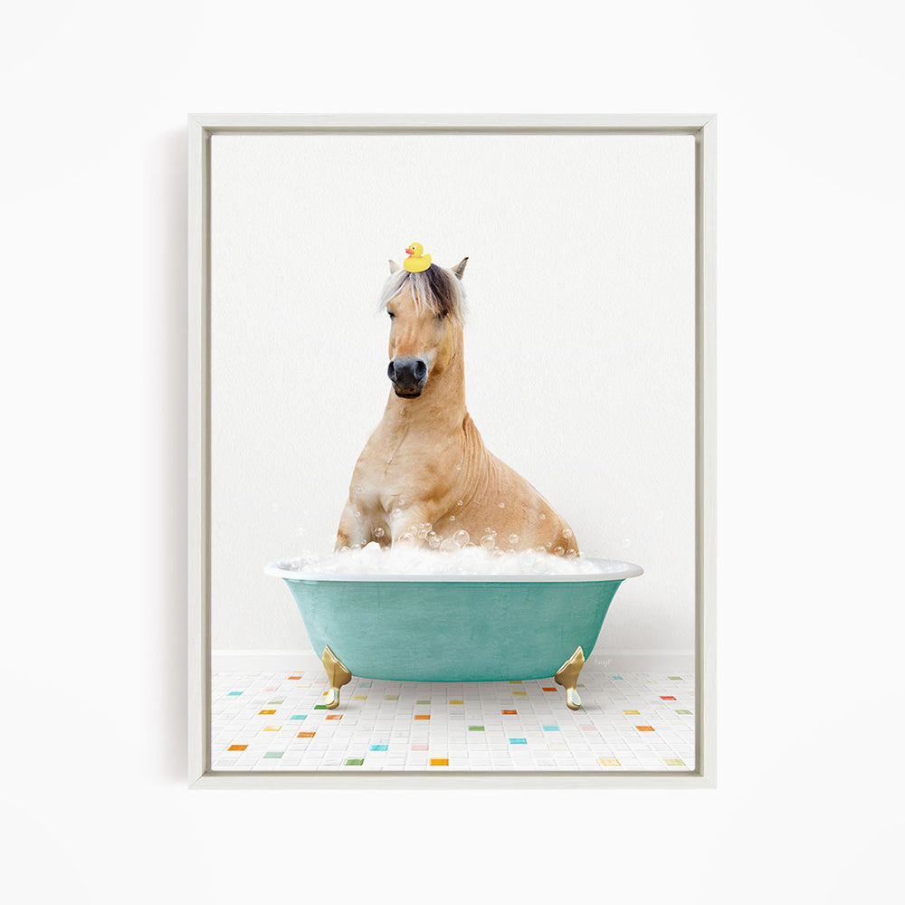 A light brown horse is sitting in a blue bathtub filled with water, with a yellow rubber duck perched on its head.
