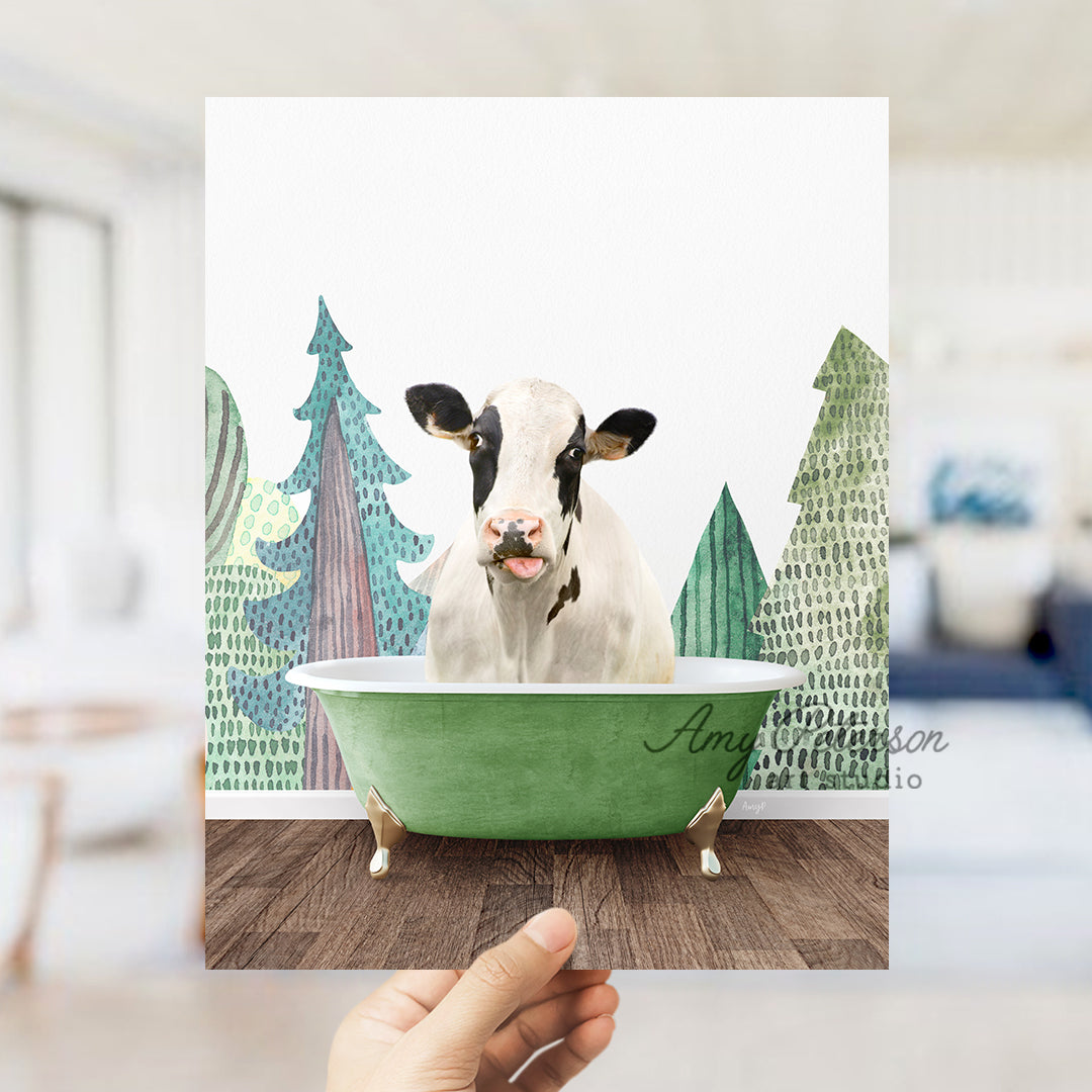 a hand holding up a card with a cow in a bathtub