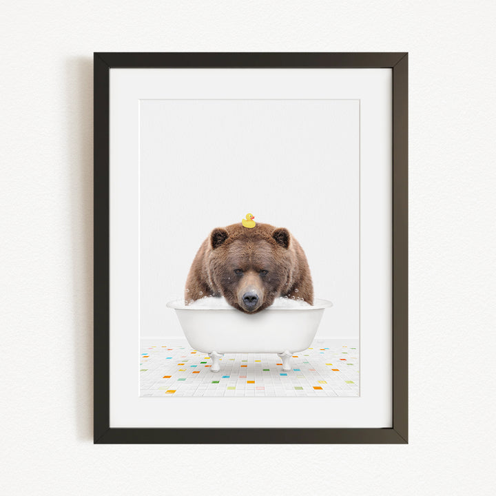 A brown bear is sitting in a white bathtub, with a yellow rubber duck perched on its head.