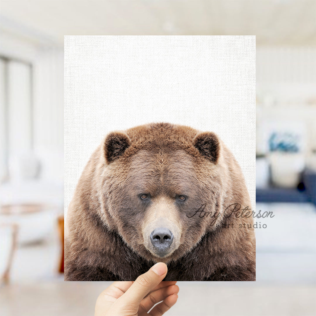 a person holding up a picture of a bear