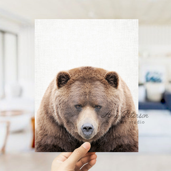 a person holding up a picture of a bear