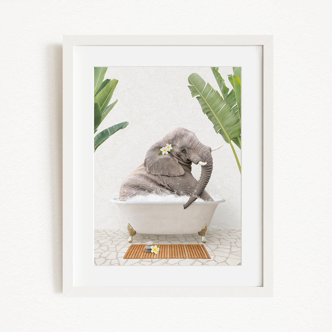 A gray elephant is sitting in a white bathtub, surrounded by green leaves and flowers, creating a whimsical and relaxing scene.