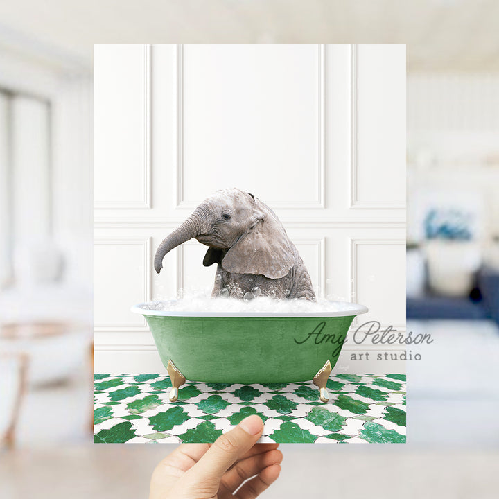 a hand holding a card with a picture of a baby elephant in a bathtub