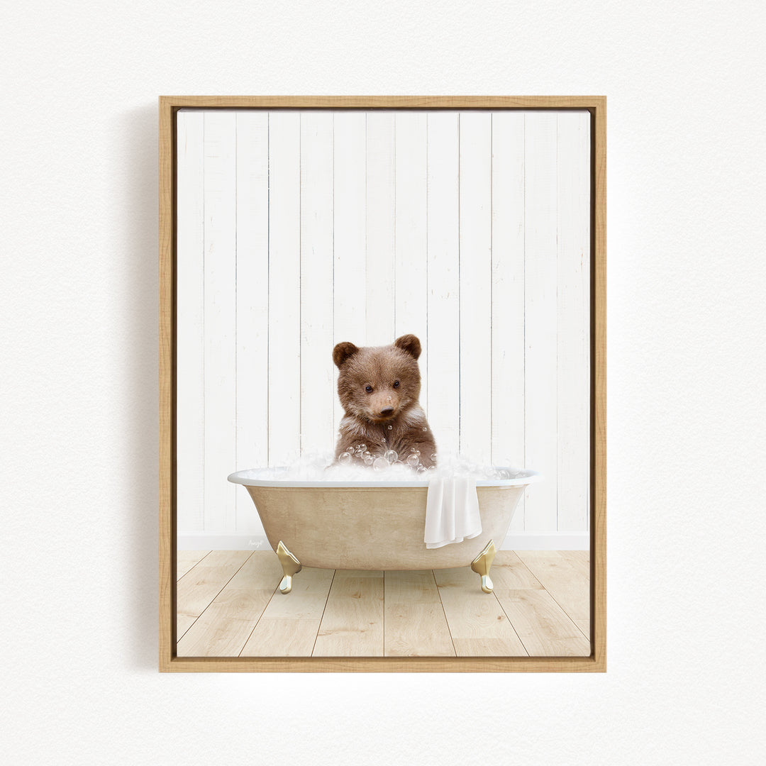 A brown bear sitting in a bathtub filled with water, surrounded by a white wooden wall.