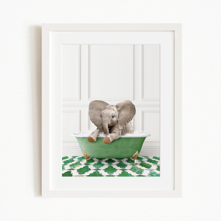 A baby elephant sitting in a green bathtub filled with water, surrounded by a green and white patterned rug.