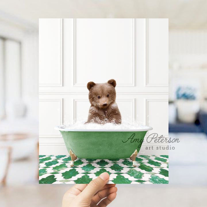 a person holding up a polaroid picture of a teddy bear in a bathtub