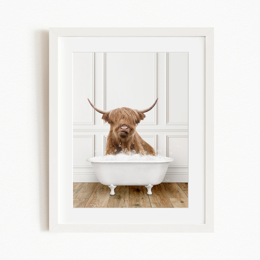 A brown cow with long horns is sitting in a white bathtub filled with water, appearing to enjoy the bath.