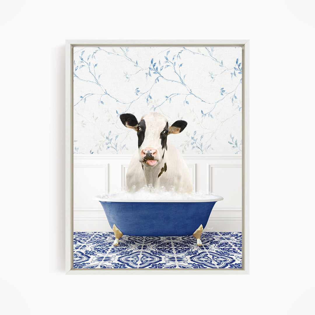 A black and white cow is sitting in a blue bathtub filled with water, creating a whimsical and humorous scene.
