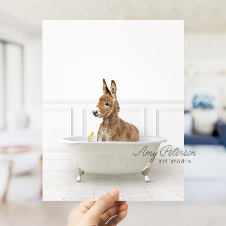 a hand holding a card with a dog in a bathtub