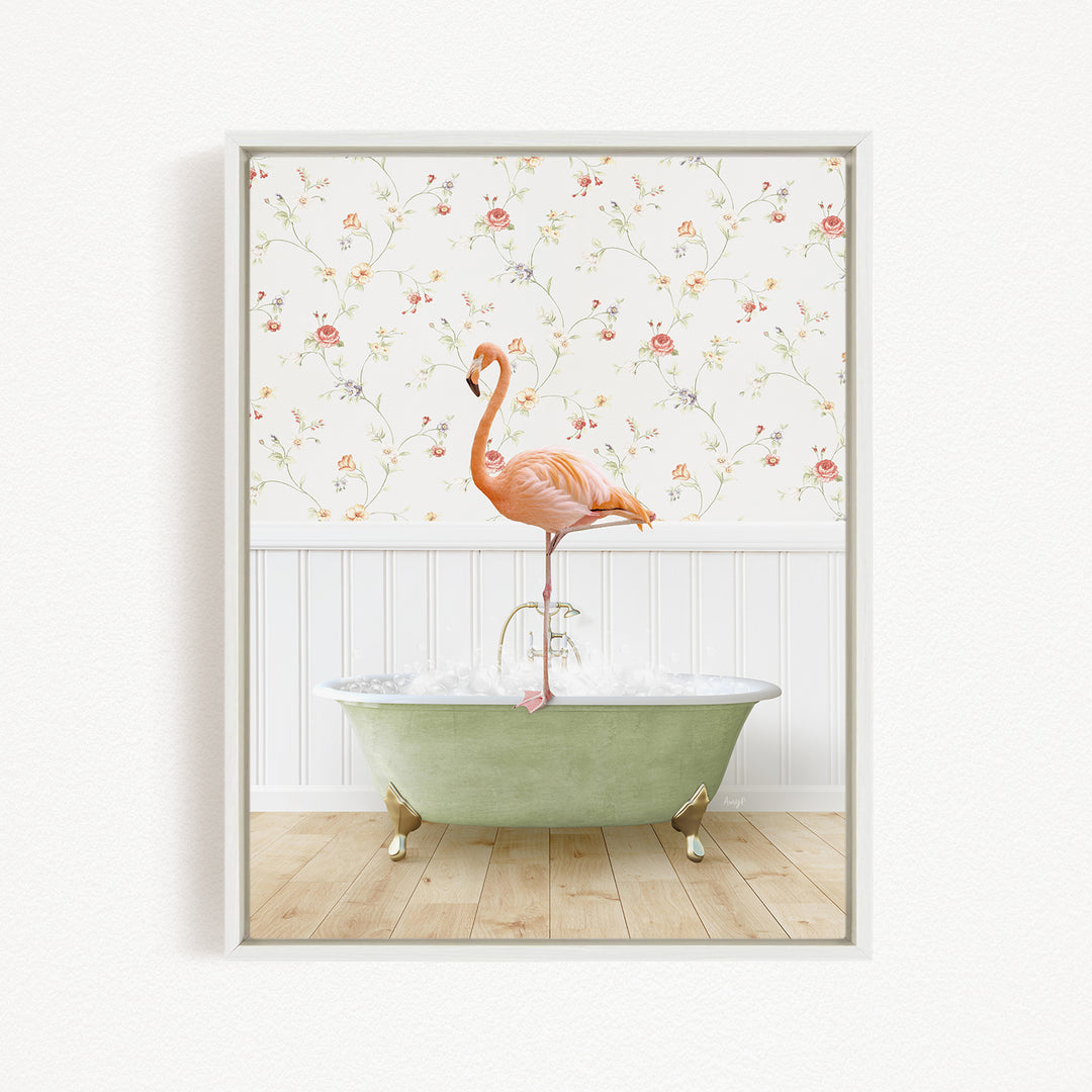 A pink flamingo stands on the edge of a green clawfoot bathtub, with a floral wallpaper in the background.