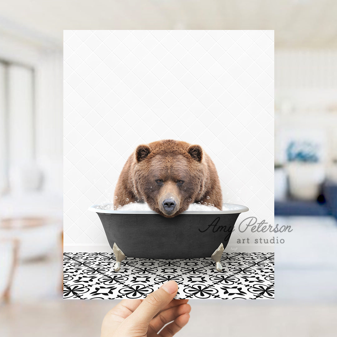 a person holding up a picture of a bear in a bathtub