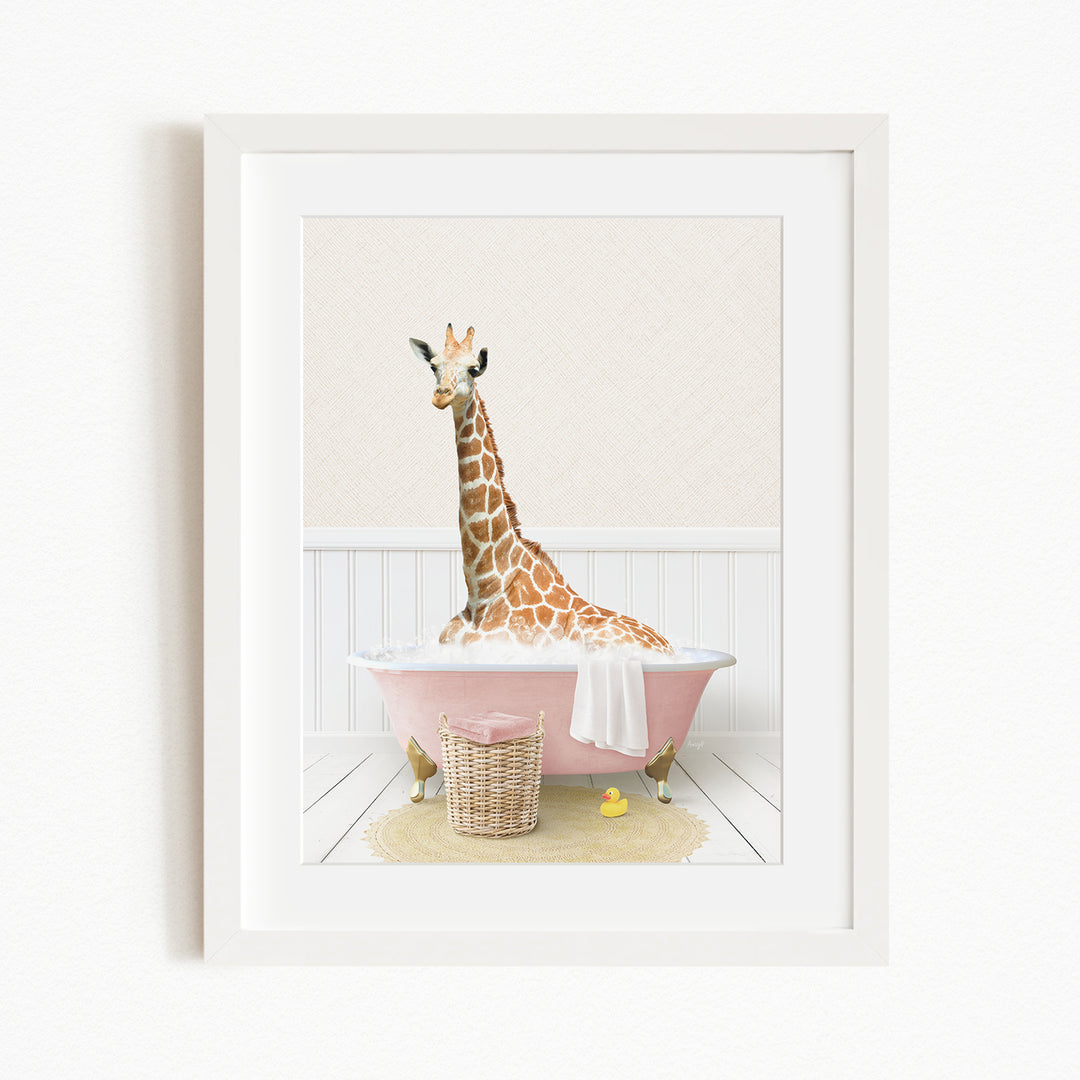 A giraffe sitting in a pink bathtub filled with water, surrounded by a yellow rubber duck and a basket.