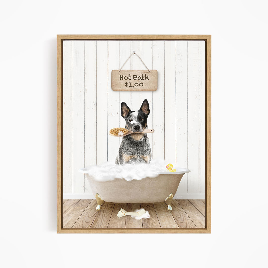 A black and white dog sitting in a white bathtub, holding a brush in its mouth, with a sign above the bathtub that reads "Hot Bath $1.00".