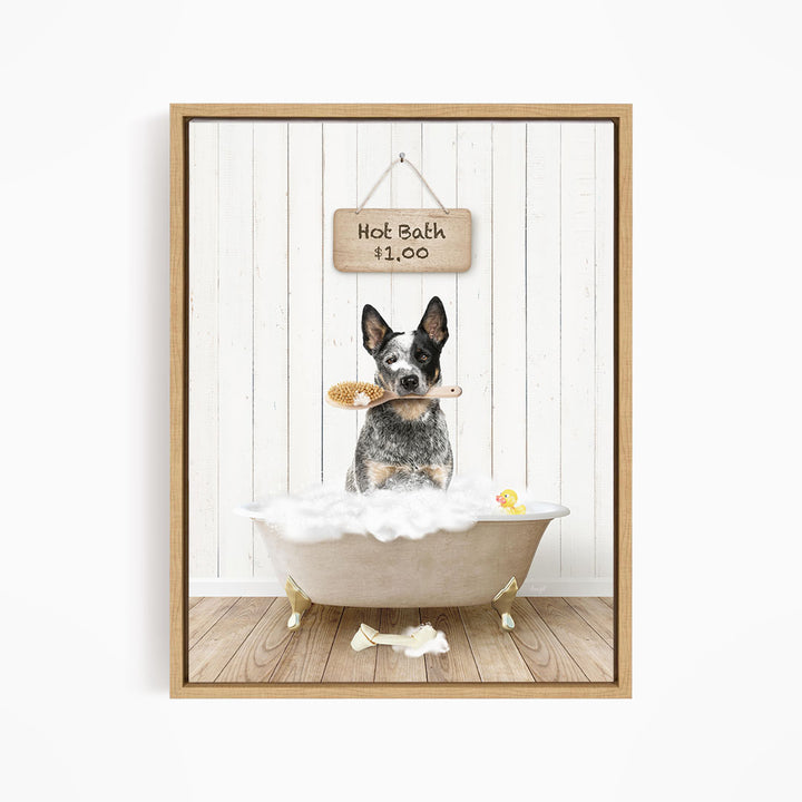 A black and white dog sitting in a white bathtub, holding a brush in its mouth, with a sign above the bathtub that reads "Hot Bath $1.00".
