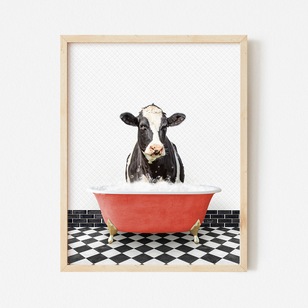 a black and white cow in a red bathtub