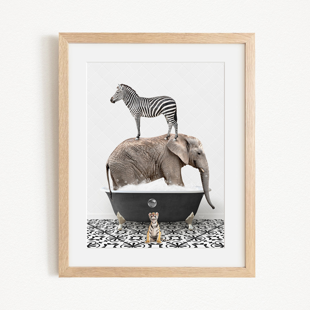 A framed image depicting a zebra standing on an elephant's back while an elephant is submerged in a bathtub, with a tiger sitting nearby.