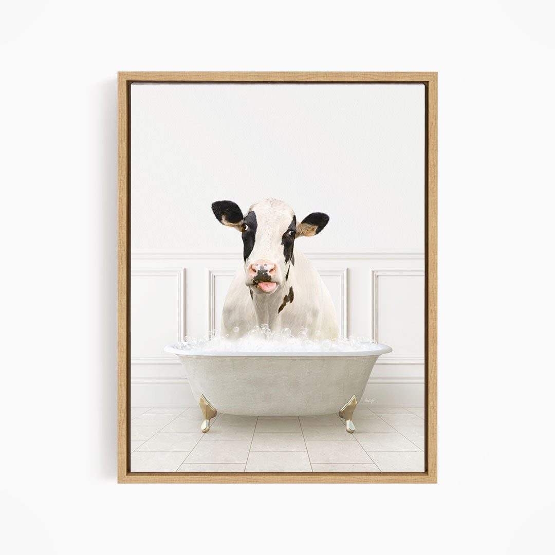 A black and white cow is sitting in a white bathtub filled with water, creating a whimsical and humorous scene.