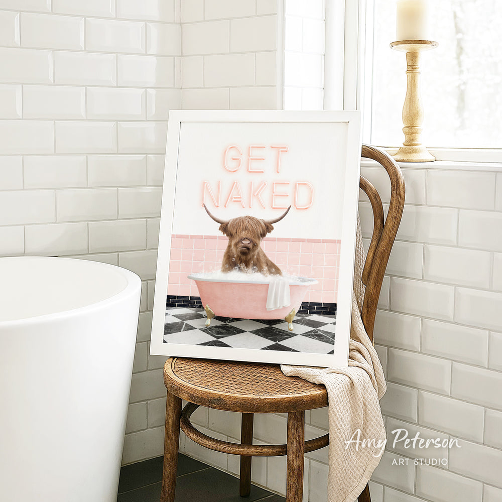 A framed image of a dog sitting in a pink bathtub, with the text "GET NAKED" displayed on the frame.