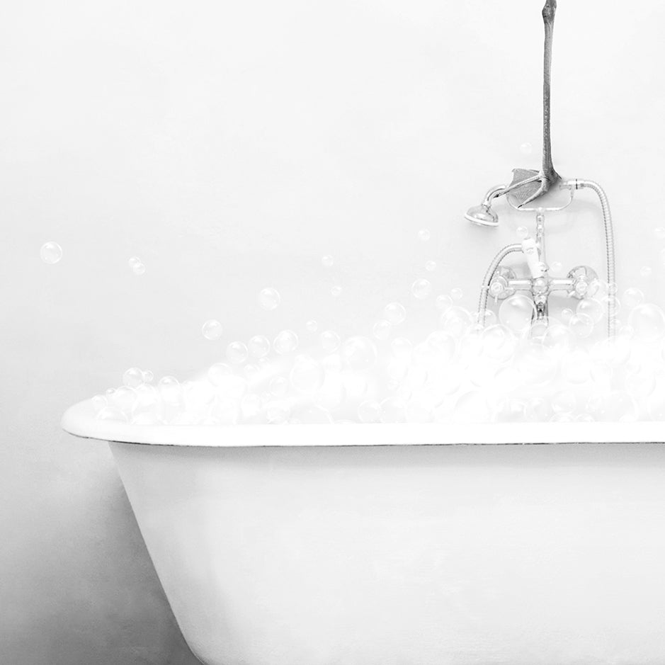 a bathtub filled with bubbles and a faucet