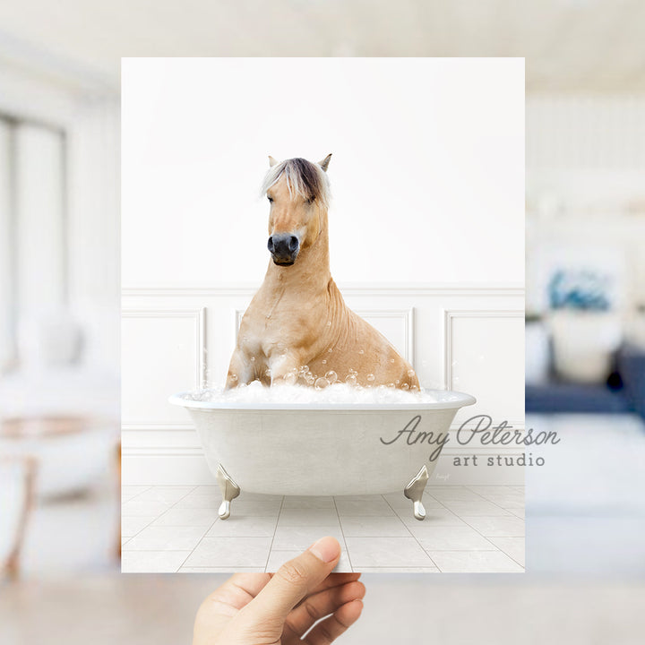 a hand holding a card with a horse in a bathtub