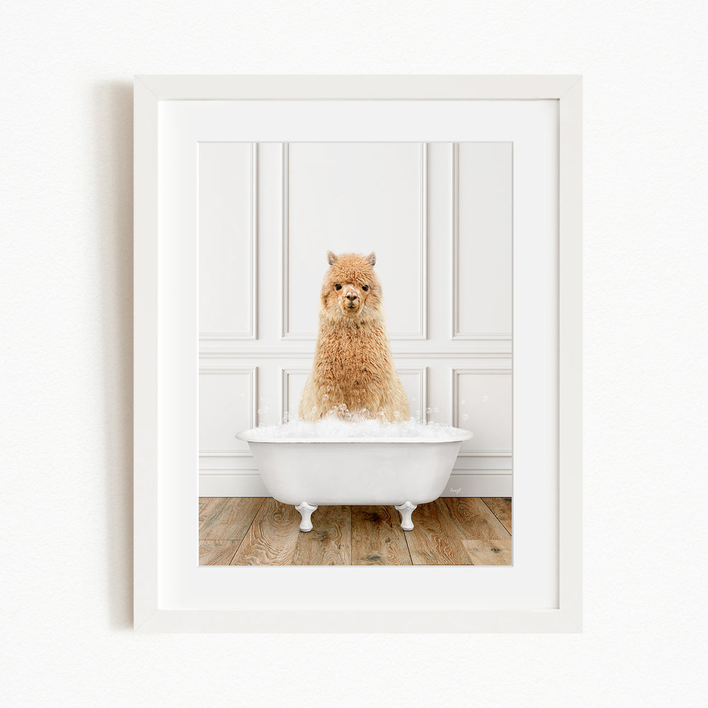 A fluffy brown alpaca sitting in a white bathtub filled with bubbles, creating a whimsical and adorable scene.