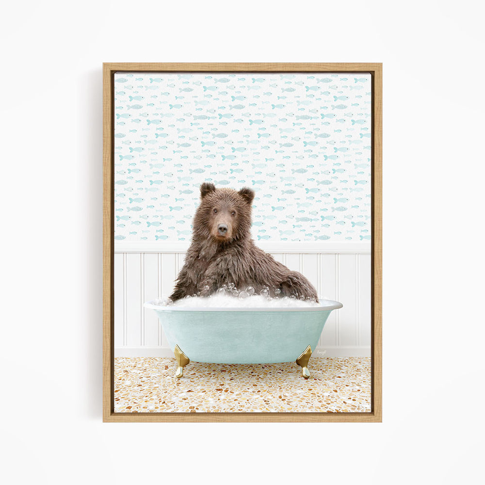 A brown bear sitting in a blue bathtub filled with bubbles, surrounded by a patterned wall.