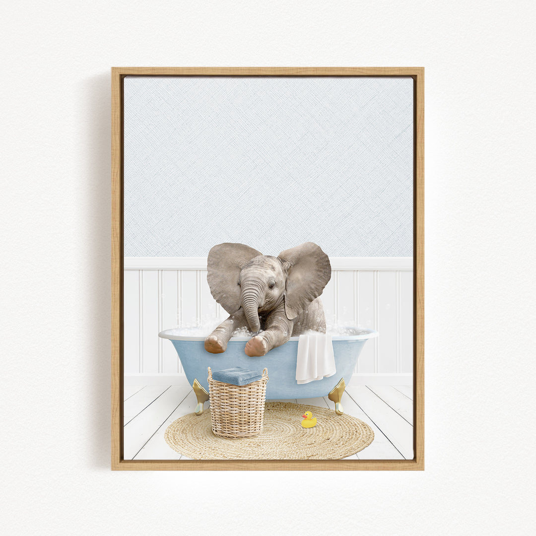 A baby elephant sitting in a blue bathtub, surrounded by a yellow rubber duck and a woven basket.