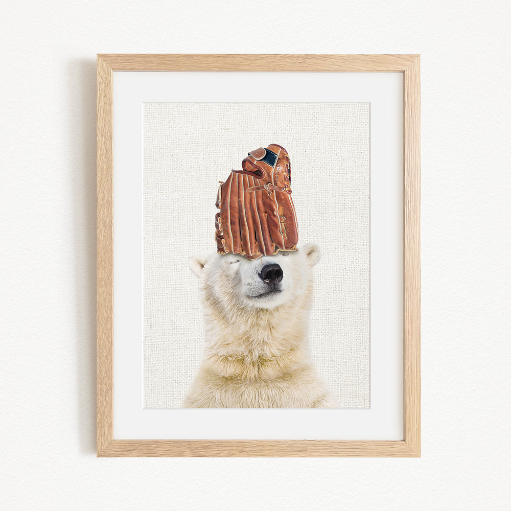 A polar bear wearing a baseball glove on its head, with its eyes closed, in a framed artwork.