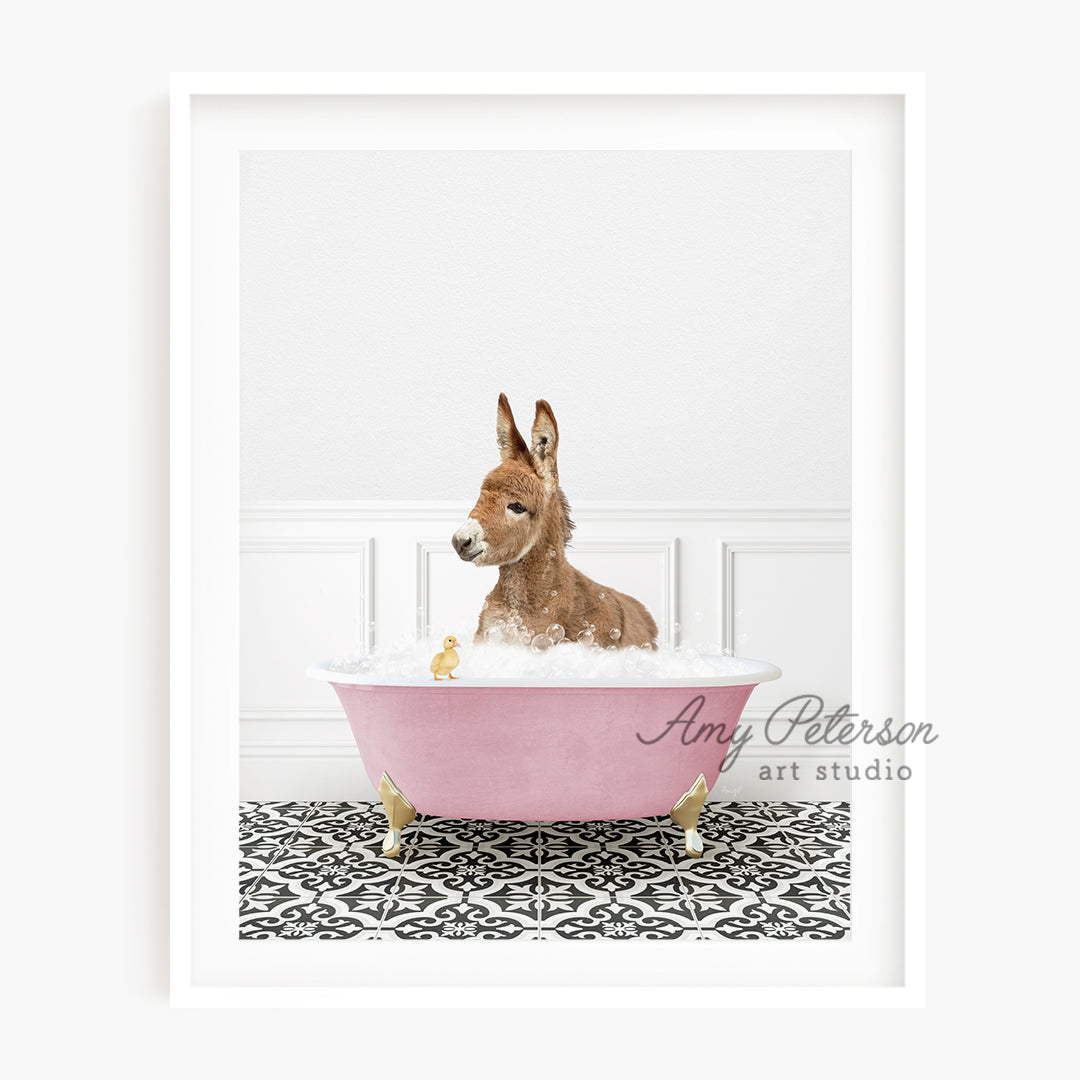 a brown dog sitting in a pink bath tub