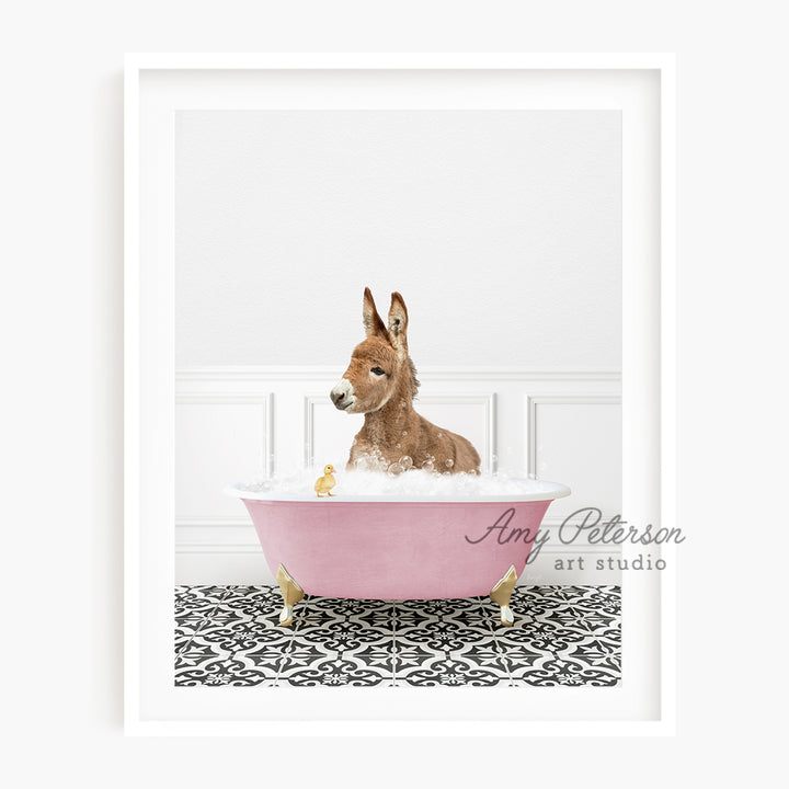 a brown dog sitting in a pink bath tub