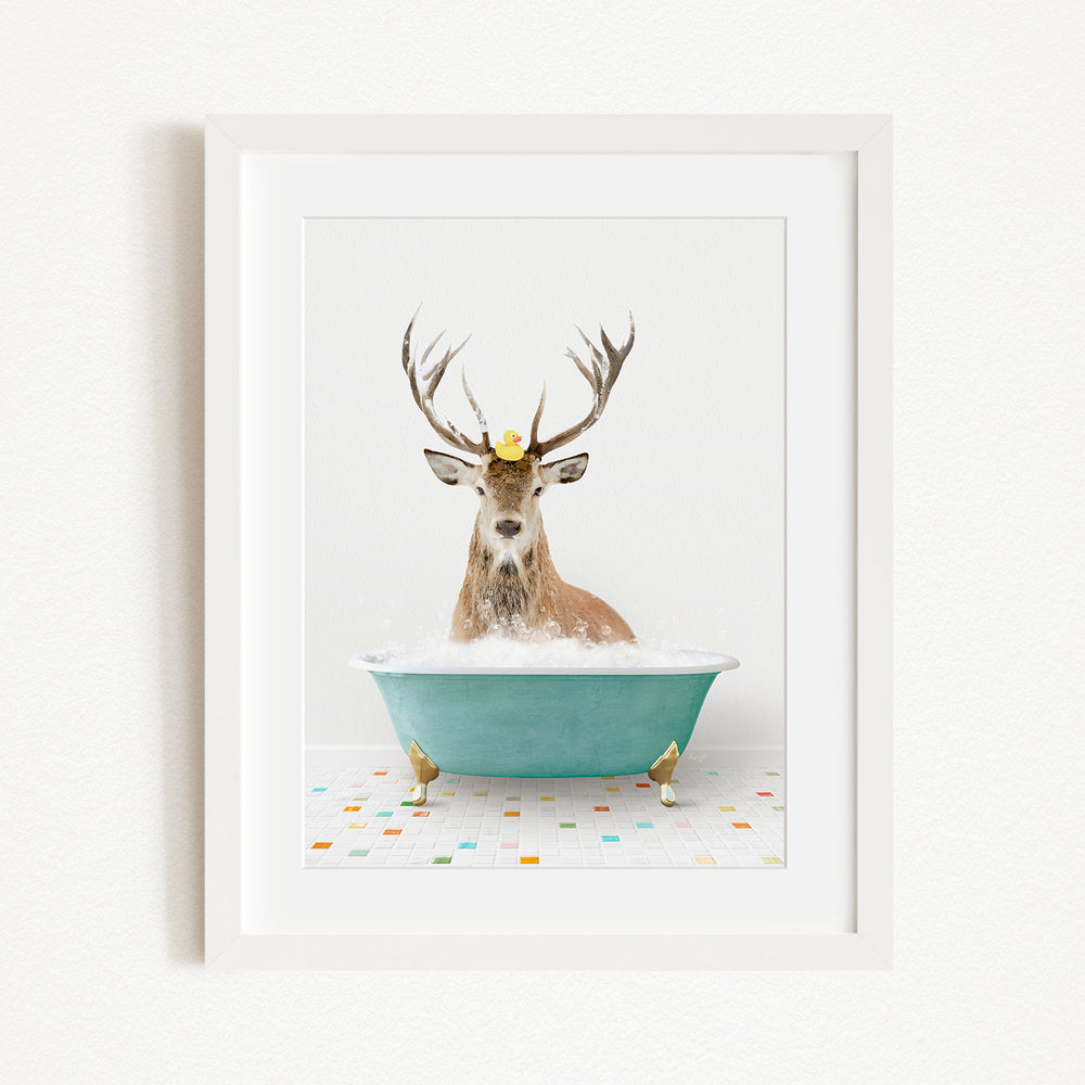 A deer with antlers is sitting in a green bathtub filled with bubbles, with a yellow rubber duck perched on its head.