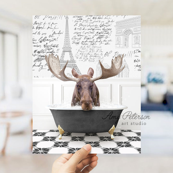 a person holding up a card with a picture of a moose in a bathtub