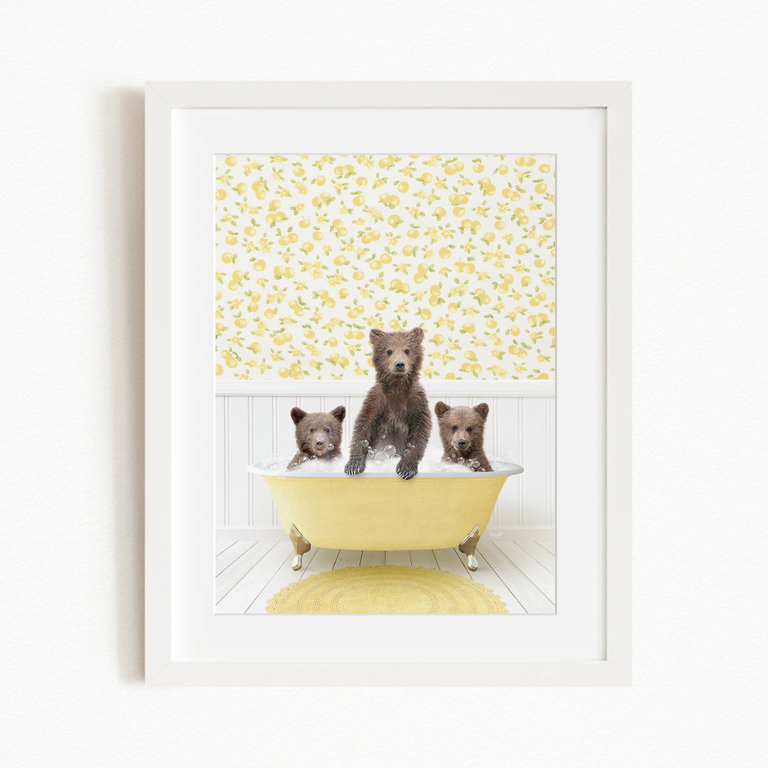 Three adorable brown bears sitting in a yellow bathtub, with a yellow floral wallpaper in the background.