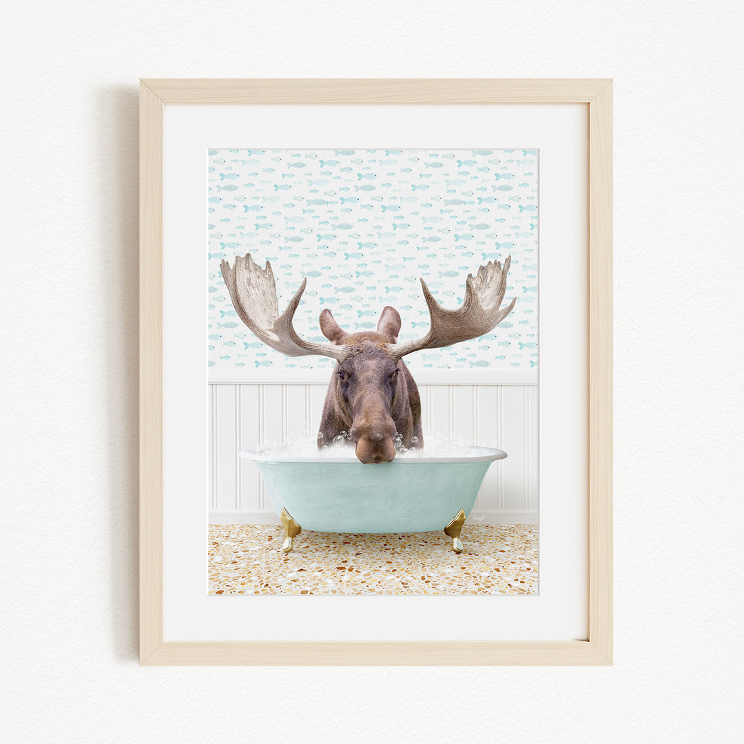 A moose with large antlers is sitting in a light blue bathtub, surrounded by a patterned wall and a beige floor.