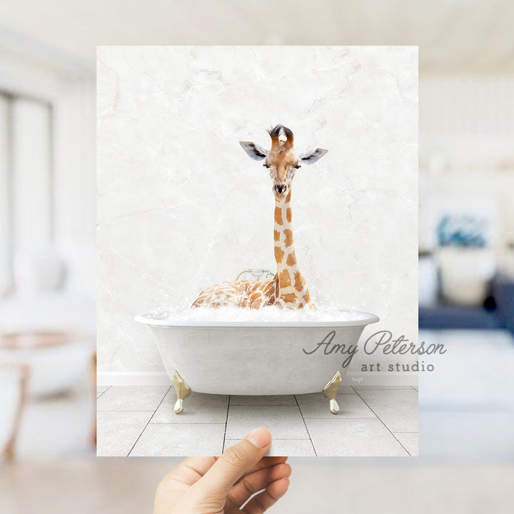 a hand holding up a picture of a giraffe in a bathtub