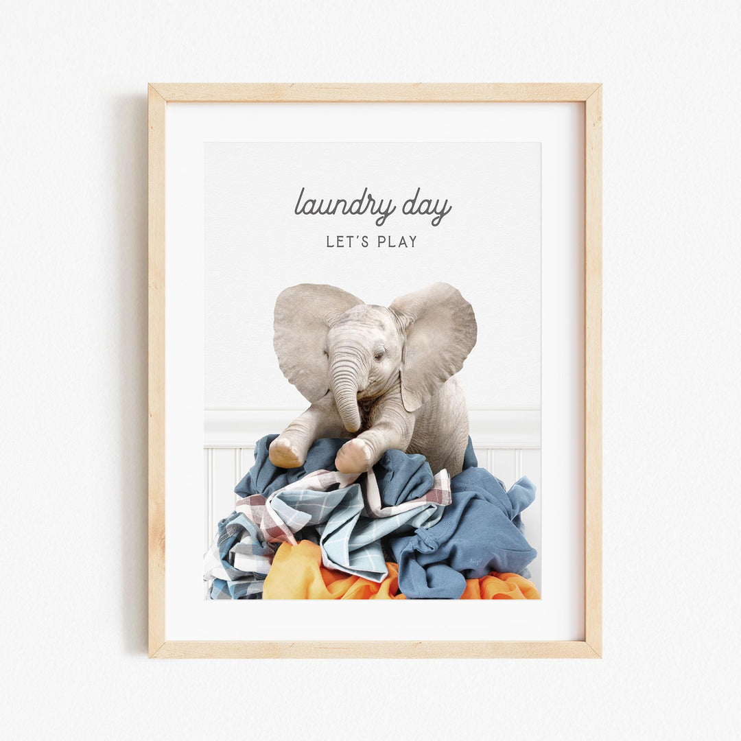 a picture of an elephant sitting on top of a pile of clothes