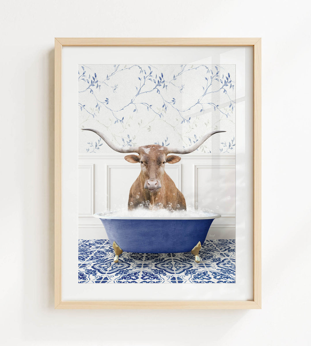 A brown cow with large horns is sitting in a blue bathtub filled with water, surrounded by a blue and white patterned tile floor.