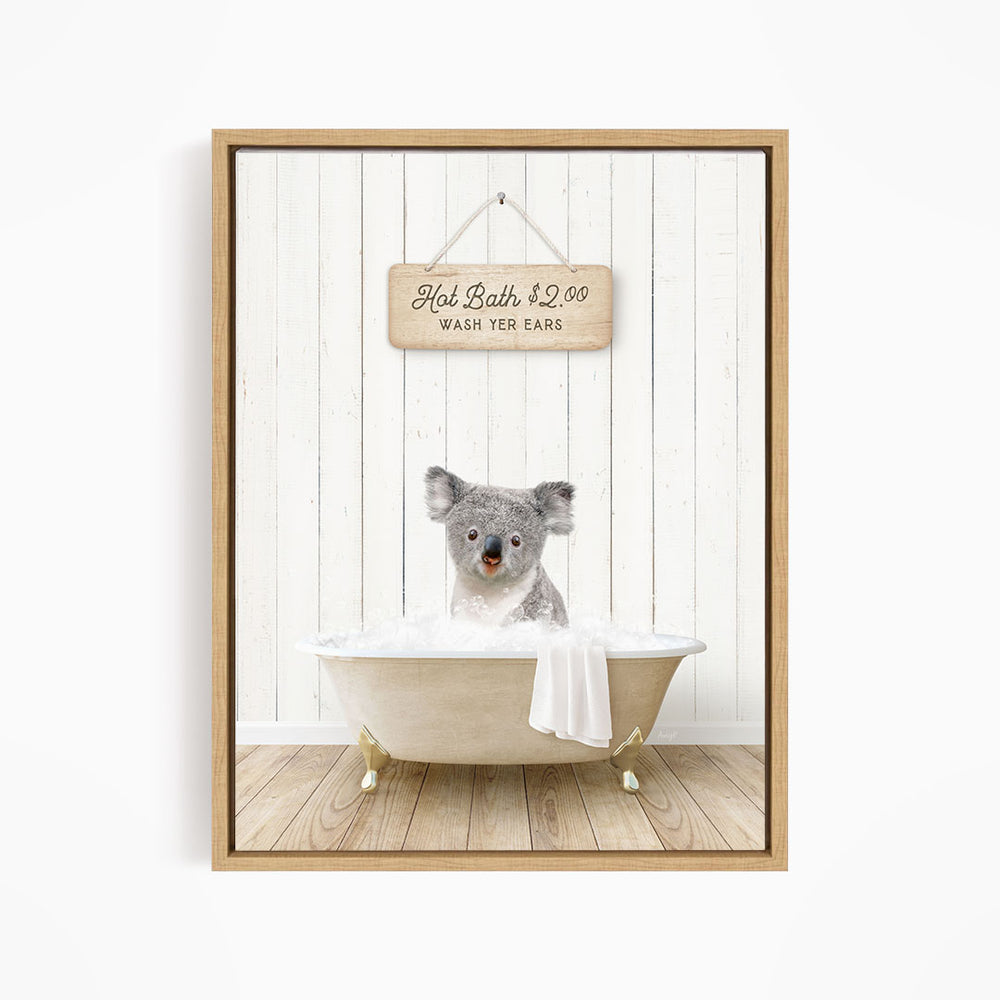 A koala bear sitting in a bathtub, with a wooden sign above that reads "Hot Bath $2.00 WASH EARS".