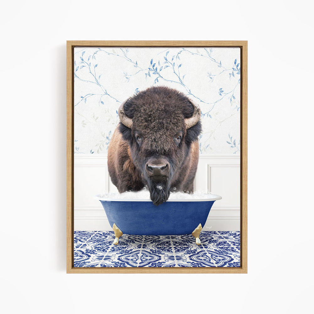 A buffalo with a long, shaggy mane is standing in a blue bathtub, with its head poking out of the tub.