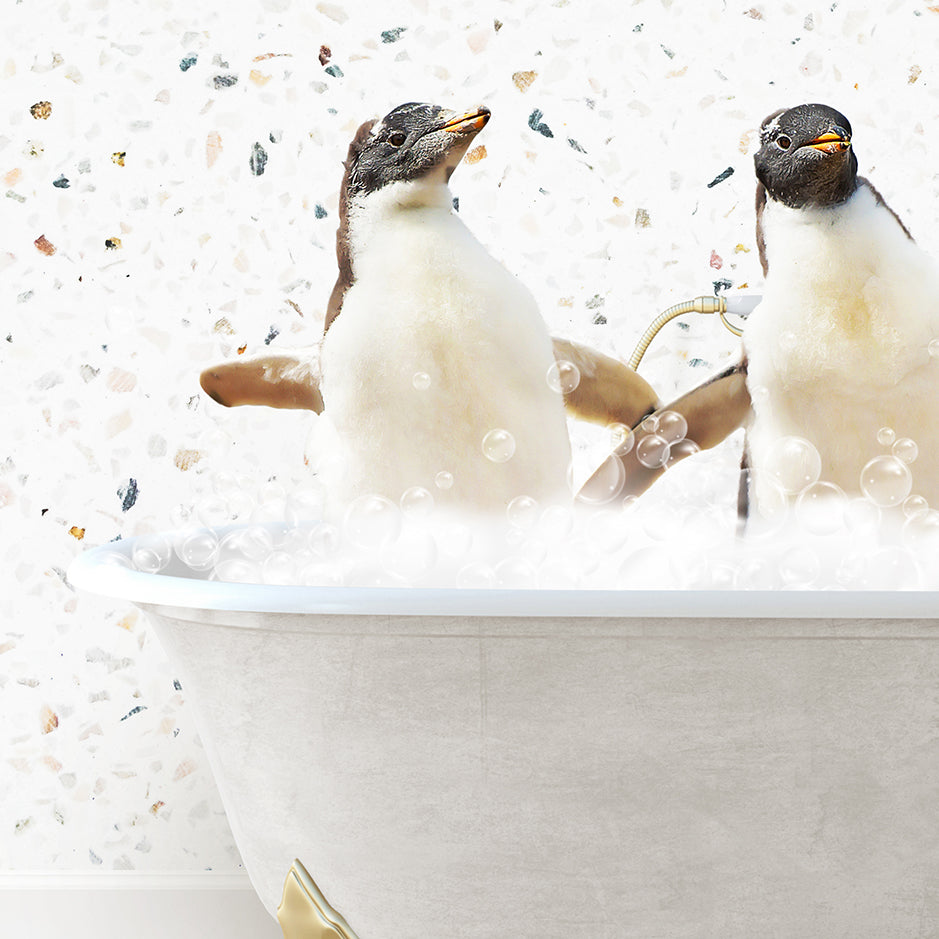 two penguins sitting in a bathtub with bubbles