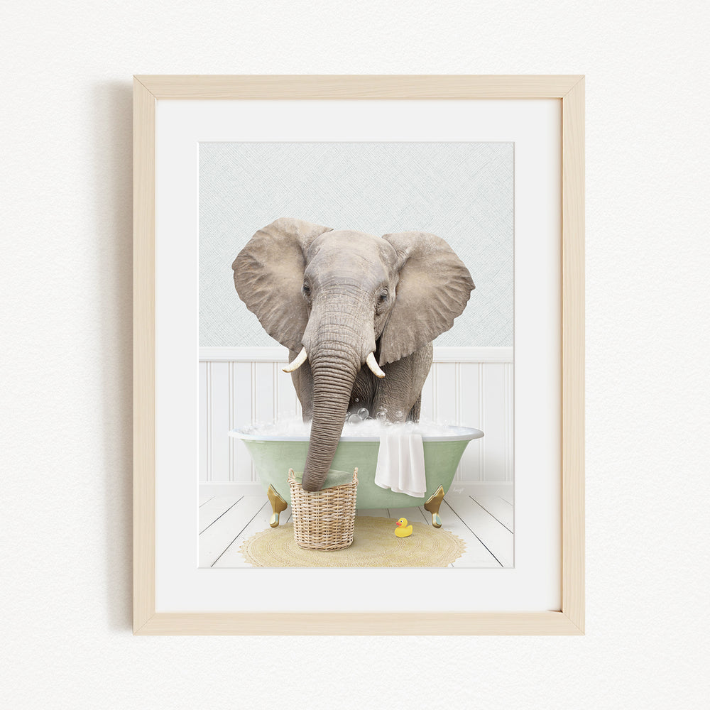 A gray elephant is sitting in a green bathtub filled with water, surrounded by yellow rubber ducks.