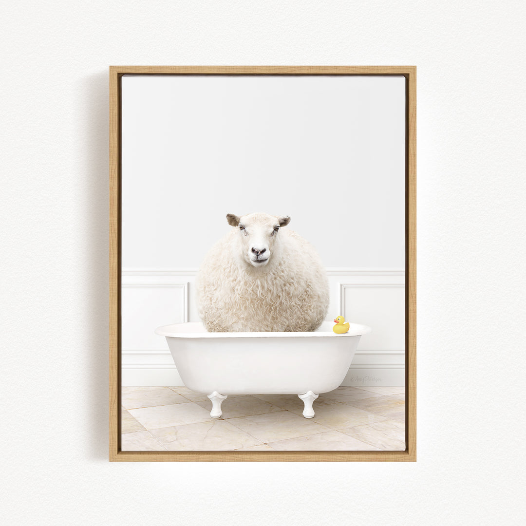 A fluffy white sheep sits in a white bathtub, with a yellow rubber duck floating on the water.