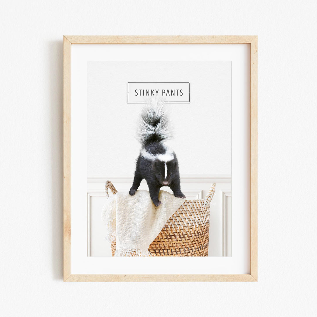 a black and white animal sitting on top of a basket